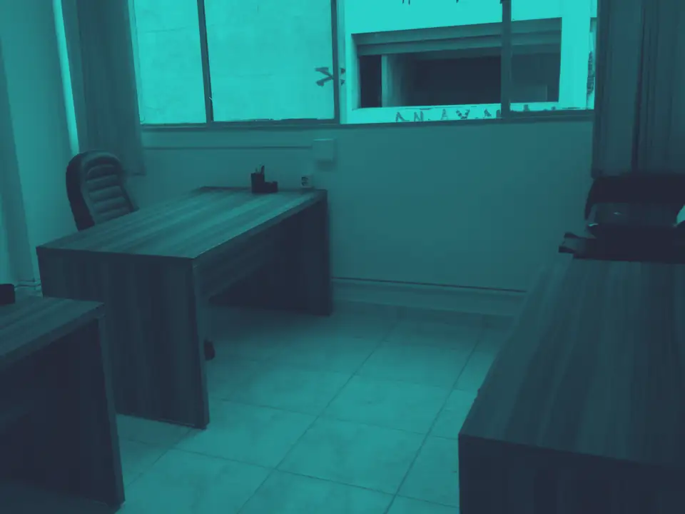 Sala recém-montada da primeira sede, no centro de Goiânia, com duas mesas de trabalho e uma janela ao fundo